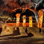 A family of woodspirits carved by Chainsaw Jenna greets visitors at Carved © Kathryn Rapier