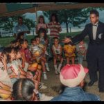 A young Tom Frank performs magic for children.